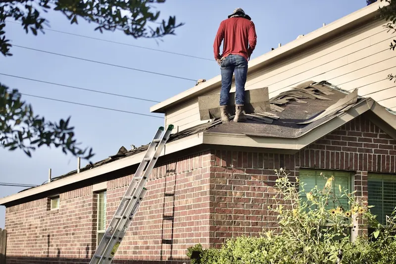 Professional roofer working on a residential roof in Eloise